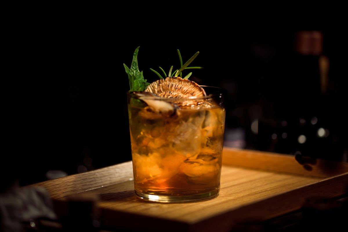A cocktail on a dark bar
